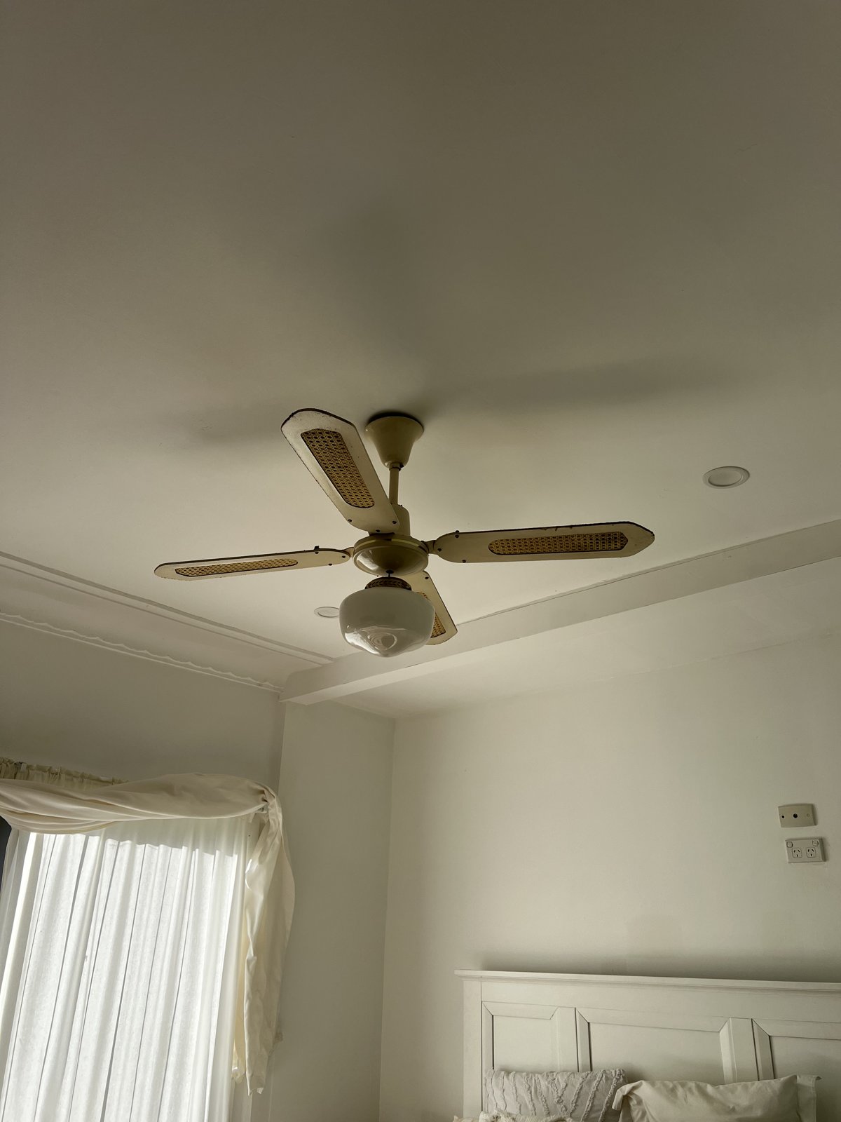 Old white ceiling fan installed on ceiling